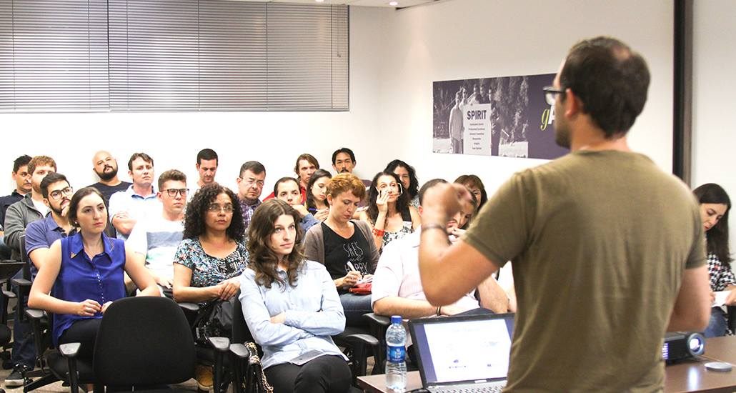 Packed room watching a talk.